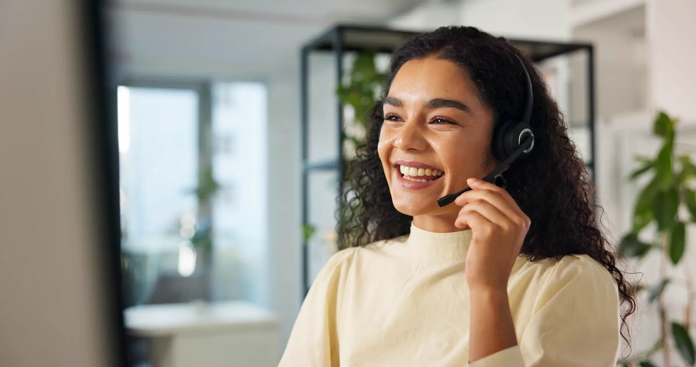 A member of the inquiries team on a headset, mid-conversation.